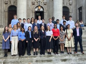 Large professional group photo of young adults in business clothes on classical building steps