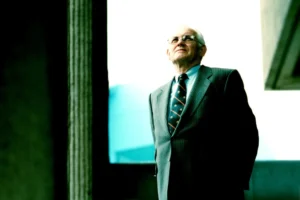 Man in business suit and glasses looking upward in modern architectural interior