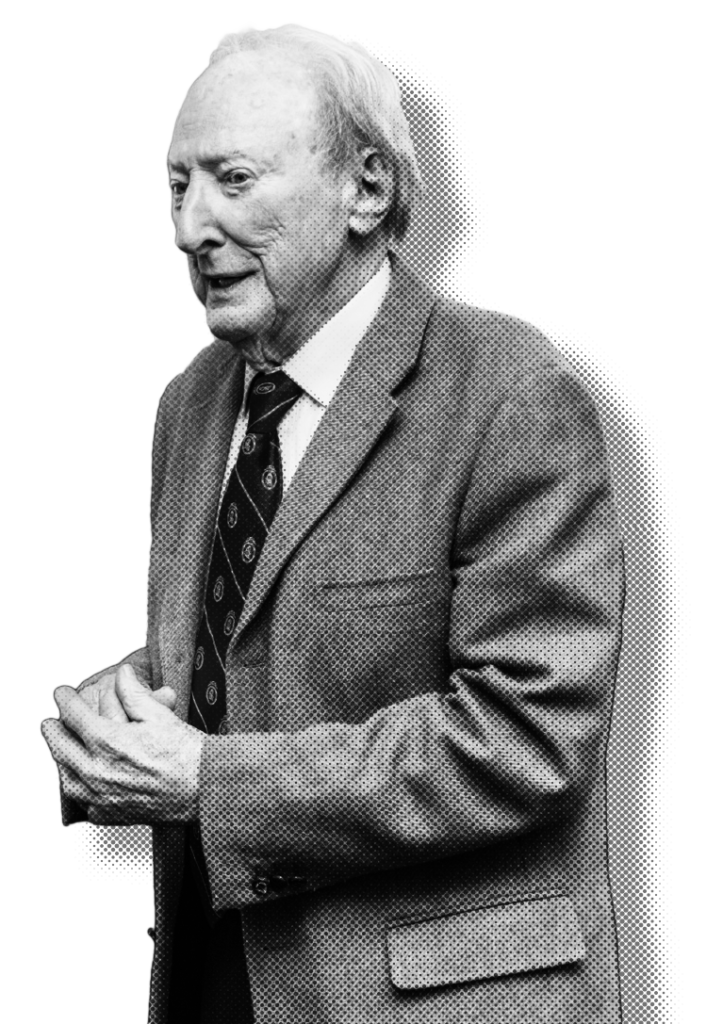 Black and white profile portrait of a man in suit and tie against white background